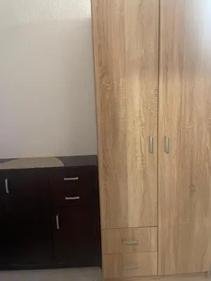 a large wooden cabinet next to a desk at Apartmani Marina Sutomore in Sutomore