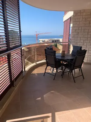 a patio with a table and chairs on a balcony at Anatolia in Becici