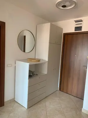 a kitchen with a white cabinet and a mirror at Anatolia in Becici