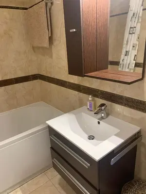 a bathroom with a sink and a tub and a mirror at Anatolia in Becici