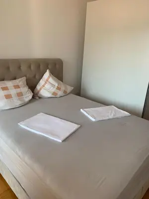 a bed with two napkins and two pillows on it at Anatolia in Becici