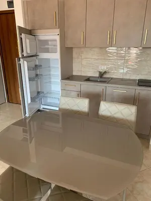 a kitchen with a table and an open refrigerator at Anatolia in Becici