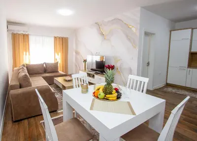 a living room with a white table with a bowl of fruit at Apartment Numa - Ulcinj in Ulcinj