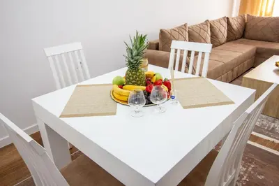 a white table with a bowl of fruit on it at Apartment Numa - Ulcinj in Ulcinj