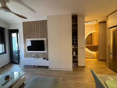 a living room with a couch and a tv at Una Dobra Voda in Dobra Voda