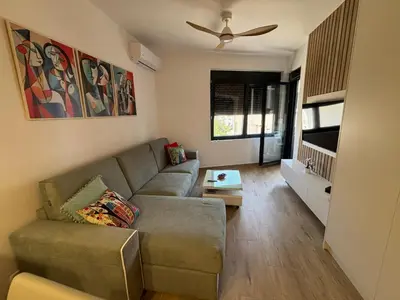 a living room with a couch and a ceiling fan at Una Dobra Voda in Dobra Voda