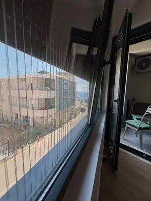 a room with a window with a view of a building at Una Dobra Voda in Dobra Voda