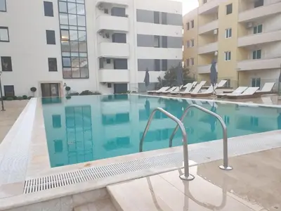 a swimming pool in front of a building at Una Dobra Voda in Dobra Voda