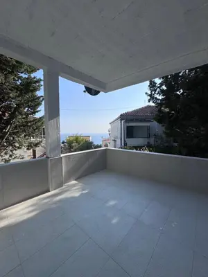 an outdoor balcony with a view of the ocean at Ulcinja Apartment Pinjes in Ulcinj