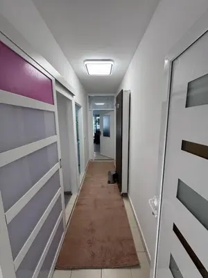 a corridor of an office building with doors and a hallway at Ulcinja Apartment Pinjes in Ulcinj