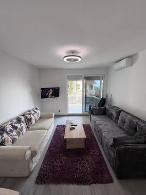 a living room with a couch and a coffee table at Ulcinja Apartment Pinjes in Ulcinj