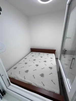 a small bed in a room with a window at Ulcinja Apartment Pinjes in Ulcinj