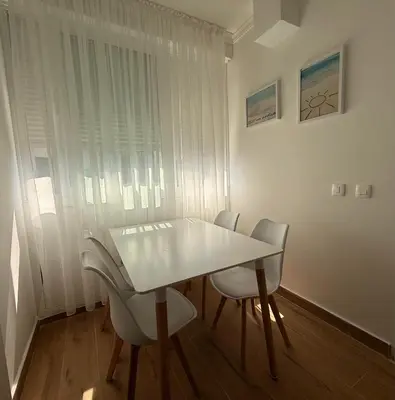 a white table and chairs in a room at Itana by the sea in Budva