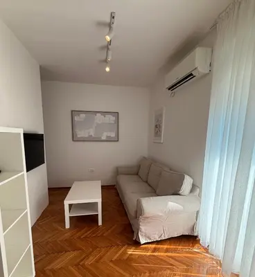 a living room with a couch and a table at Itana by the sea in Budva
