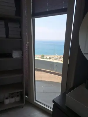 a bathroom with a door open to a view of the ocean at Skyline sea view apartment in Becici