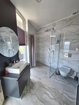 a bathroom with a sink and a shower and a toilet at Skyline sea view apartment in Becici