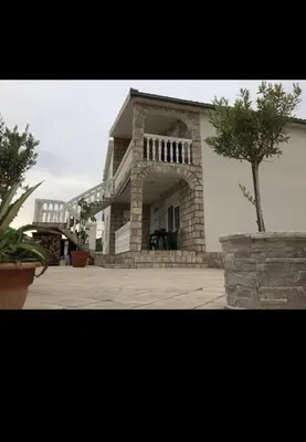 a large building with a tree in front of it at SeaMontAdriatic in Bar