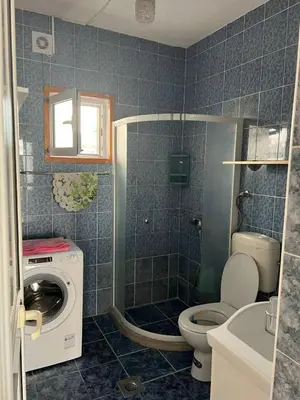 a bathroom with a washing machine and a toilet at SeaMontAdriatic in Bar