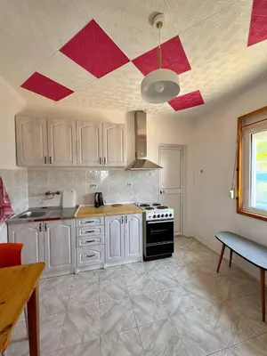 a kitchen with white cabinets and a red ceiling at SeaMontAdriatic in Bar