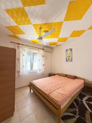 a bedroom with a bed and a yellow and white ceiling at SeaMontAdriatic in Bar