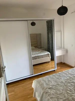 a mirror in a room with a bed and a bedroom at Disa&Nuzi in Ulcinj