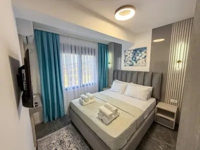 a bedroom with a bed with two towels on it at Urban Nest Apartment in Ulcinj
