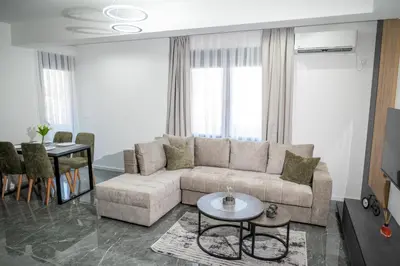 a living room with a couch and a table at Urban Nest Apartment in Ulcinj