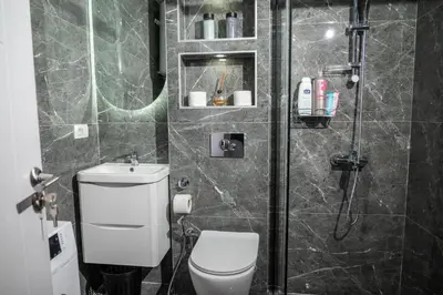 a bathroom with a shower and a toilet and a sink at Urban Nest Apartment in Ulcinj