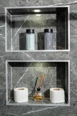 a shelf with three rolls of toilet paper on it at Urban Nest Apartment in Ulcinj