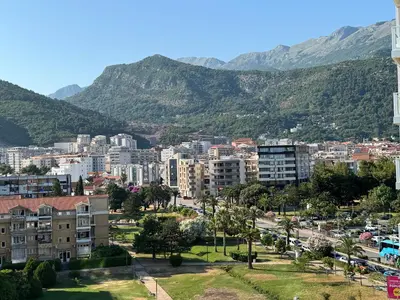 a city with buildings and mountains in the background at Tre Family in Budva