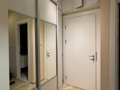 a room with two doors and a mirror at Tre Family in Budva
