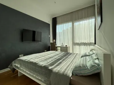 a bedroom with a large bed and a window at Tre Family in Budva