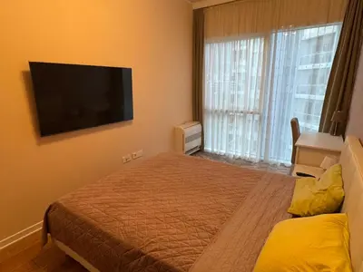a bedroom with a bed and a flat screen tv at Tre Family in Budva