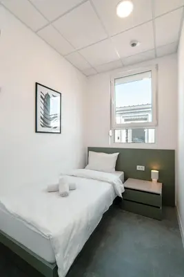 a bedroom with two beds and a window at TQ City Apartments in Radanovići