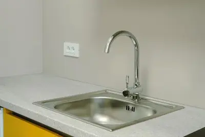 a stainless steel sink in a kitchen at TQ City Apartments in Radanovići