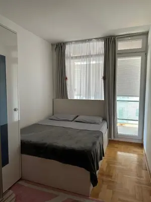 a bedroom with a bed and a large window at Dubovica Hill in Budva