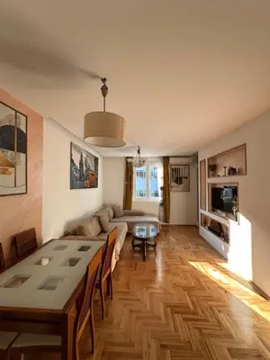a living room with a table and a couch at Dubovica Hill in Budva