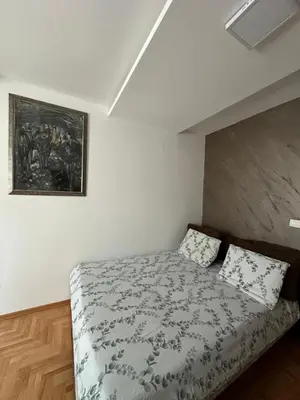 a bedroom with a bed and a painting on the wall at Dubovica Hill in Budva