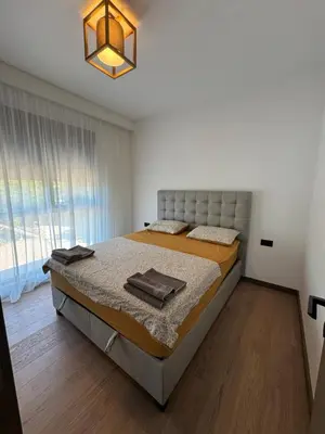 a bedroom with a bed and a large window at Pine & Sea in Bar