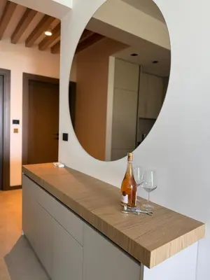 a bottle of wine on a counter with a mirror at Pine & Sea in Bar