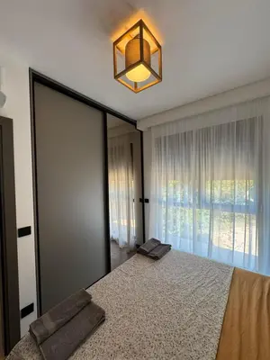 a bedroom with a large mirror and a bed at Pine & Sea in Bar