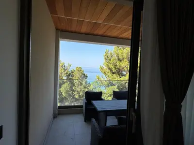 a room with a window with a table and a view at Pine & Sea in Bar