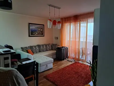 a living room with a couch and a window at Apartman More i Nebo in Petrovac na Moru