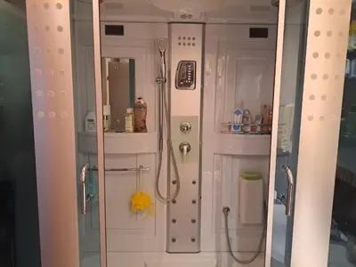 a bathroom with a shower and a toilet and a mirror at Apartman More i Nebo in Petrovac na Moru