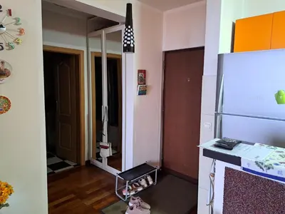 a small room with a refrigerator and a hallway at Apartman More i Nebo in Petrovac na Moru