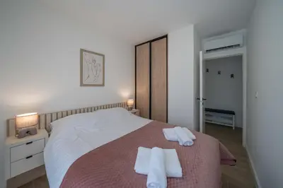 a bedroom with a bed with two towels on it at Mia Stella in Kotor