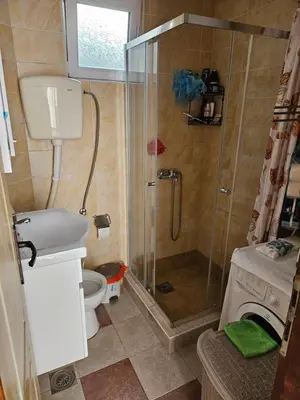 a small bathroom with a shower and a toilet at Apartman Stepanović in Budva