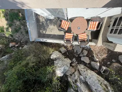 an overhead view of a patio with chairs and rocks at Apartmani Ilić in Utjeha
