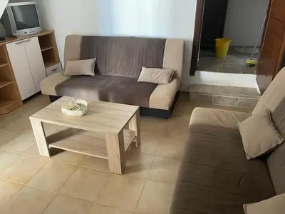a living room with a couch and a coffee table at Apartmani Ilić in Utjeha