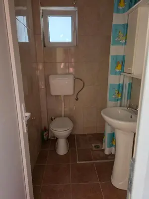 a small bathroom with a toilet and a sink at Ekilo in Dobra Voda